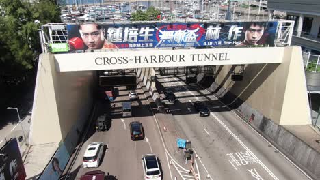 Traffic-heading-in-and-out-of-Hong-Kong-cross-harbor-tunnel,-Aerial-view