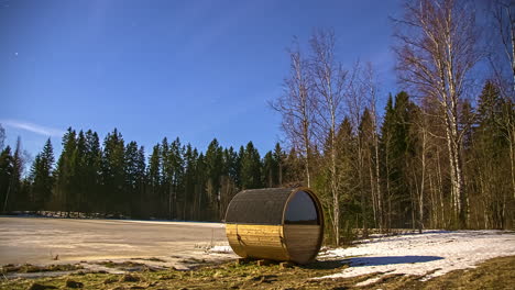 a-thermowood-tub-sauna-in-wild-countryside-surrounded-by-coniferous-trees