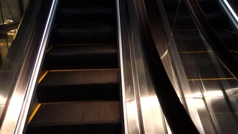 long-empty-escalator-inside-building,-moving-staircase