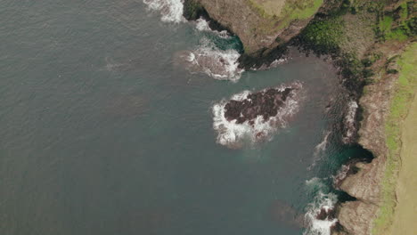 Bird's-eye-view-flying-over-cliffs,-Grimsey-Island-in-Arctic-Circle-near-Iceland