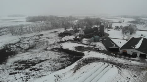 Drone-shot-of-farm-house-in-the-winter-with-snow