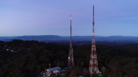 Slow-clockwise-orbit-around-TV-communications-antenna-during-purple-dusk-evening