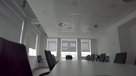 Ansicht-Des-Modernen-Konferenzraums-Mit-Weißem-Interieur,-Schwarzen-Stühlen,-Weißem-Langem-Tisch-Und-Großen-Fenstern-Mit-Vorhängen