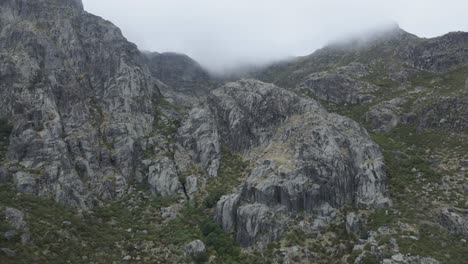 Rocky-mountain-shrouded-in-clouds,-Covao-da-Ametade-in-Serra-da-Estrela,-Portugal