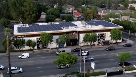 Chase-banking-business-building-with-solar-rooftop-panels-urban-aerial-view-above-town-street,-Encino,-CA