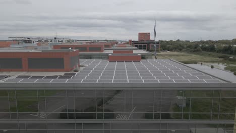 Modern-Office-With-Solar-Power---Solar-Panels-On-Top-Of-Smart-Office-Unit-In-Park-West-Business-Park,-Dublin,-Ireland---drone-shot