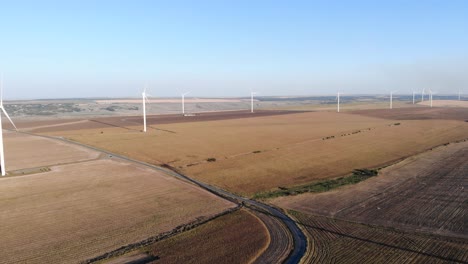 Rotating-Sustainable-Energy-Wind-Farm-Turbines-On-Summer-Countryside
