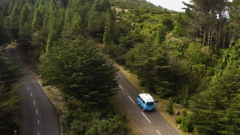 Aerial-follows-a-VW-Camper-van-that-drives-on-a-empty-road-on-Madeira,-Portugal