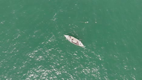 Wooden-Boat-Floating-In-Turquoise-Ocean-Waters-Off-Balochistan