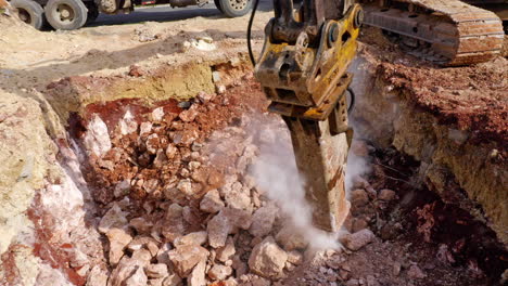 Excavator-Hydraulic-Hammer-Digging-On-The-Ground-At-Construction-Site