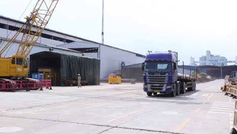 Trailer-Truck-Leaving-Warehouse-To-Transport-Fabricated-Steel-Structures