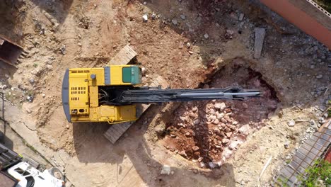 Top-View-Of-Excavator-Working-At-Construction-Site