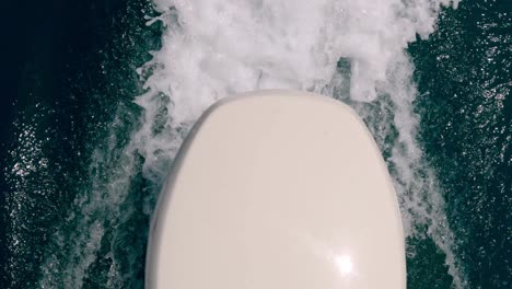 Unusual-and-unique-high-angle-pov-of-motorboat-engine-leaving-sea-water-wake