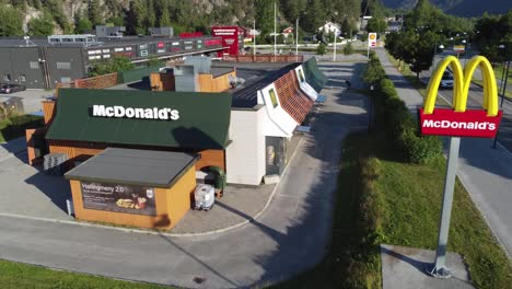 Mcdonalds-restaurant-and-roadsign-in-afternoon-sunset---Slowly-sideways-moving-aerial-revealing-full-restaurant-exterior---Flaa-Norway