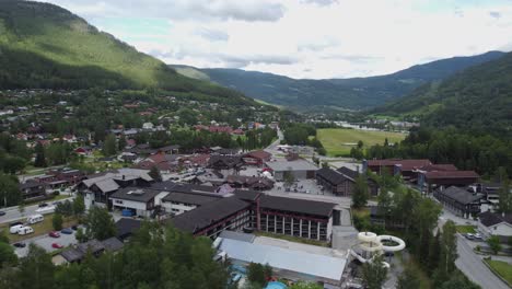 Town-of-Gol-in-Norway-with-Pers-hotel-in-front-and-Hallingdalen-valley-in-background---Summer-day-aerial-view
