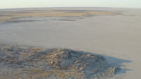 Drone-Shot-Of-Spectacular-og-Empty-Rocky-Desert-At-Kubu-Island-Near-Makgadigadi-Pans,-Botswana