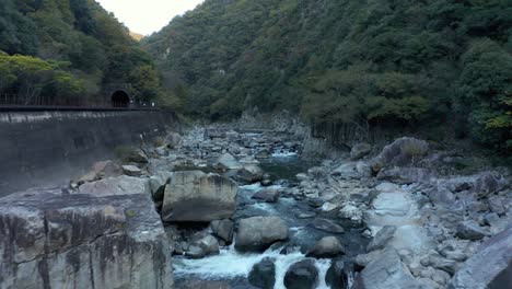Mukogawa-River-along-Takedao-Hiking-Trail,-Flying-Upstream-on-Autumn-Morning