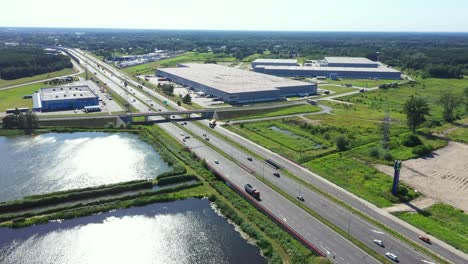 Aerial-top-view-of-the-large-logistics-park-with-warehouse,-loading-hub-with-many-semi-trailers-trucks