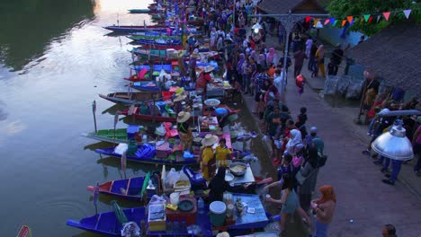 High-angle-shot-over-Khlong-Hae-Floating-Market-with-local-community-selling-local-food-to-tourists-and-locals-in-Songkhla-province,-Thailand-during-evening-time