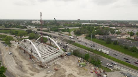 I94-freeway-and-construction-of-arch-bridge-in-Detroit,-aerial-drone-view