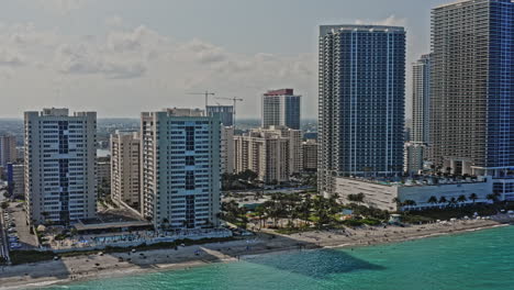 Hallandale-Beach-Florida-Aerial-v2-drone-fly-over-luxury-beachfront-condo-towers-south-city-park-reveals-golden-isles-neighborhood,-capturing-the-cityscape-and-coastal-living-lifestyle---March-2021