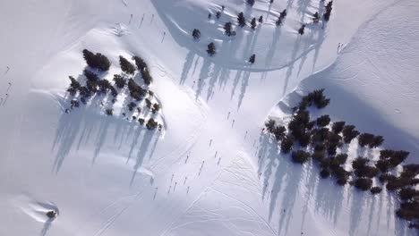 Aerial-view-of-People-Skiing-and-snowboarding-on-hill,-Ski-Resort