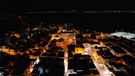 Drone-flight-over-the-streets-of-Nafplio,-Greece-at-night