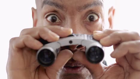binoculars-looking-through-binoculars-with-white-background-stock-video-stock-footage