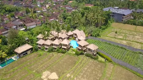 Great-aerial-view-flight-Luxury-property-in-vacation-paradise-Bamboo-hut-hotel-resort-nice-Swimming-pool-Bali,-Ubud-Spring-2017