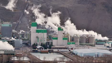 Zoom-Shot-of-Kamloops-Pulp-Mill-Emitting-Smoke-Over-the-Thompson-River-in-British-Columbia,-Canada