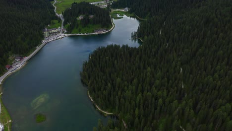 Aerial-Overhead-Flying-Over-Scenic-Lake-Misurina-With-Forest-Pine-Trees-Around-It