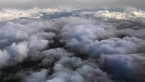 Aerial-View-above-Cloudy-Skies--from-Airplane-Window
