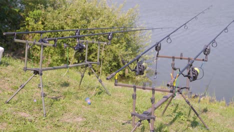 Four-fishing-lines-on-wooden-stands,-fishing-in-lake,-Varbo,-Hungary