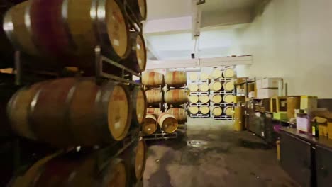 A-gimble-shot-of-many-rows-of-wooden-wine-filled-casks-lining-the-cellars-of-the-winery