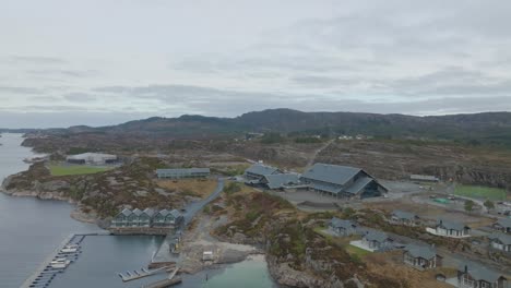 Panorama-hotel-and-resort-backward-moving-wide-angle-aerial-showing-hotel-and-surrounding-rental-apartments---Oygarden-sotra-in-western-Norway
