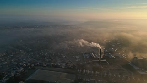 Aerial-Drone-Shot-Above-Industrial-Urban-townscape-areas-shrouded-In-morning-mist