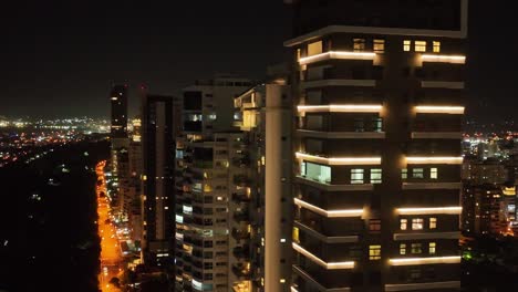 Luxury-Tower-Apartment-at-Anacona-Avenue-lighting-at-night-in-Santo-Domingo,-Dominican-Republic