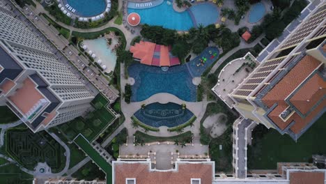 Grand-Hotel-Ho-Tram-top-down-aerial-top-down-view-tracking-over-buildings-and-swimming-pool-in-beautiful-light