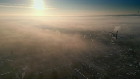 Spiritual-Scene-of-Aerial-Drone-Shot-Above-Industrial-Urban-townscape-areas-shrouded-In-morning-mist