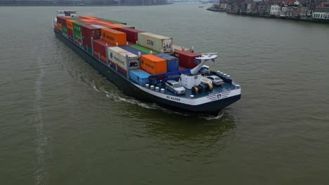 Aerial-View-Of-Scaldis-Container-Ship-Navigating-Along-Oude-Maas-On-Overcast-Day-In-Dordrecht