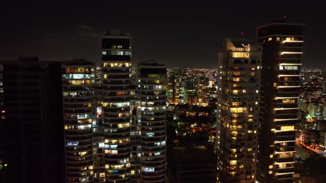 Mar-Azul-tower-residential-complex-illuminated-at-night,-Santo-Domingo-in-Dominican-Republic