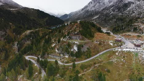 Beautiful-majestic-aerial-drone-shot-of-snow-on-Passo-di-Stalle-mountain-pass-in-Italy