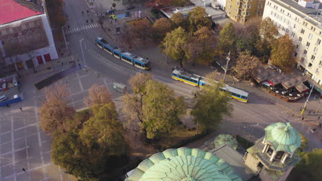 -City-transport-in-Sofia,-Bulgaria-at-Sveta-Nedelya-Square-with-a-view-of-the-mountain-and-the-pedestrian-street-Vitoshka