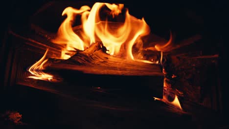 Wood-Burning-In-The-Fireplace-With-Red-Hot-Coals---close-up