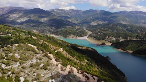 Bovilla-Reservoir-Mount-Dajti-aerial-view-of-scenic-landscape-with-tourist-standing-at-viewpoint-waiting-for-sunset