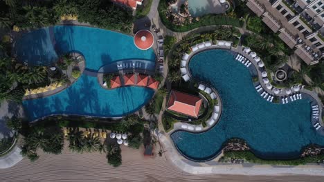 Grand-Hotel-Ho-Tram-Vietnam-top-down-aerial-view-featuring-swimming-pool-on-sunny-morning