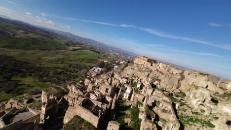 FPV-drone-flying-at-high-speed-between-the-walls-and-over-the-remains-of-the-city-of-Craco-in-Italy