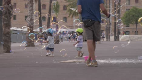 Children-playing-with-bubbles-and-having-fun-in-street-of-Barcelona