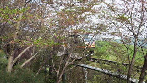 Monorail-Train-With-Sightseers-Traveling-Across-The-Railway-At-Hwadamsup-Botanical-Garden-In-Gwangju,-South-Korea