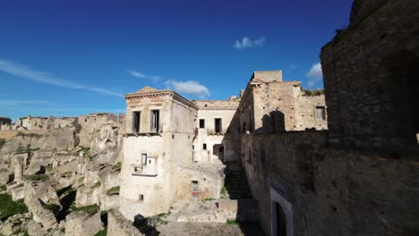 FPV-drone-flying-at-high-speed-through-the-remains-of-the-city-of-Craco-in-Italy